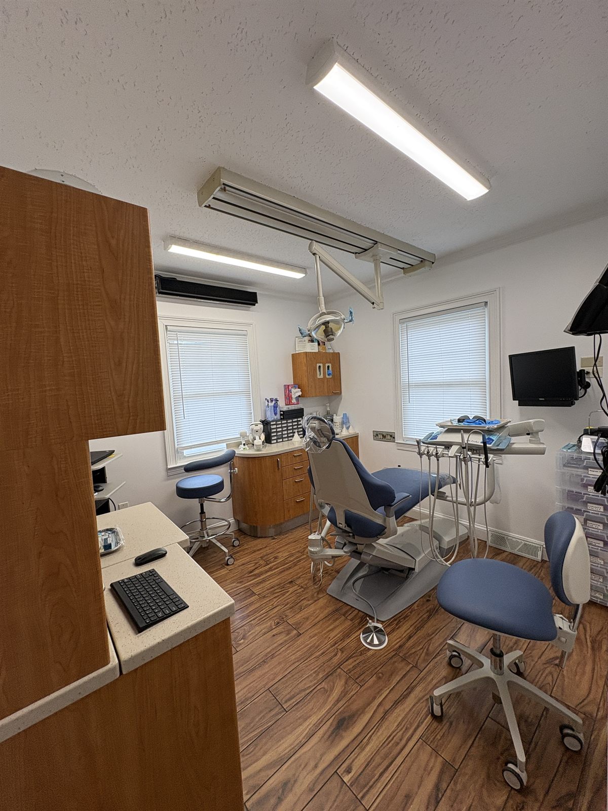 Bright operatory at Stratford Dental Care with a blue dental chair and large windows